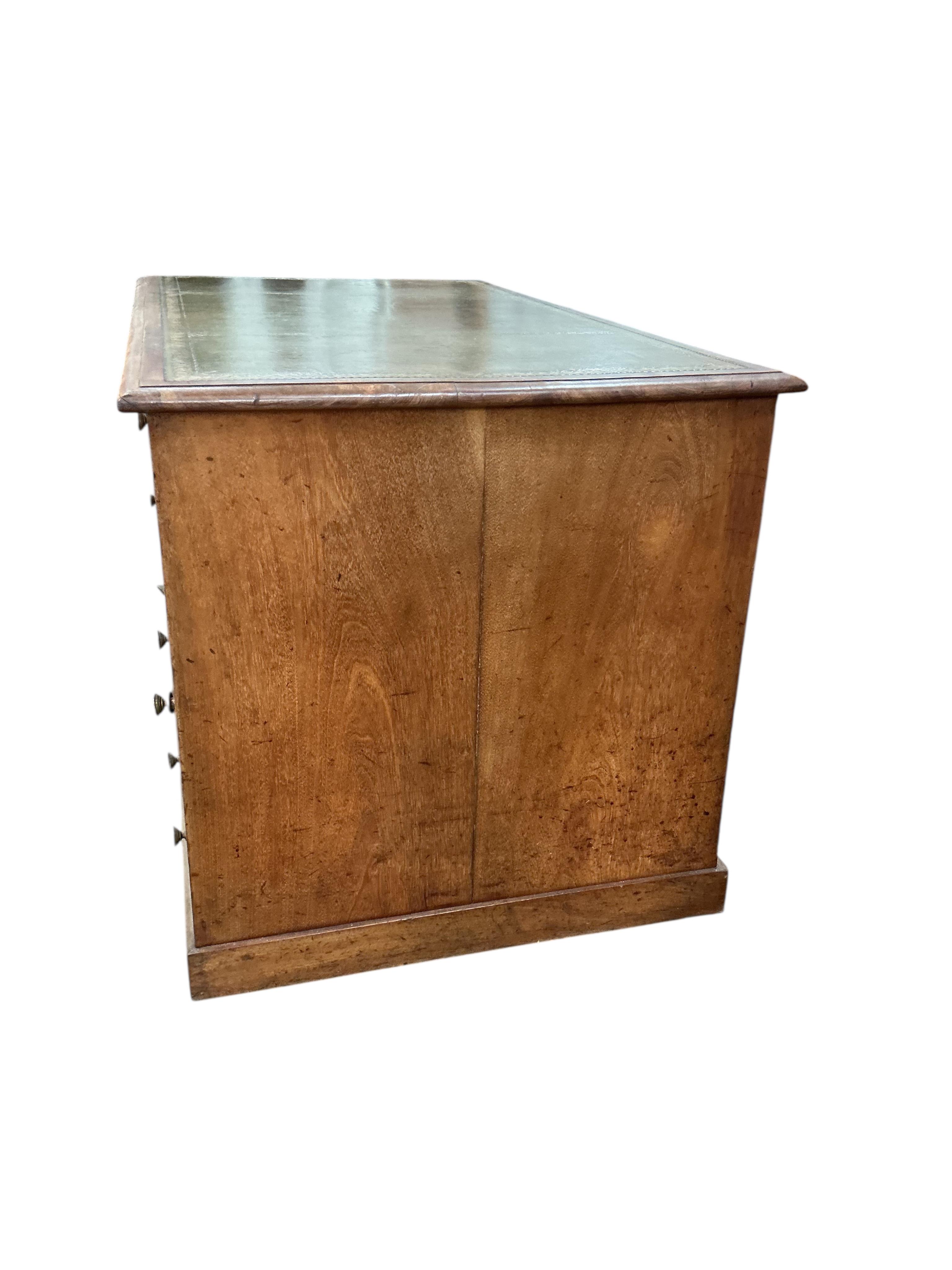 A Victorian faded mahogany kneehole desk with leather inset top, width 127cm, depth 71cm, height 77cm